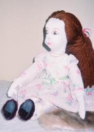 Meredith, a handmade doll, 
with sculpted body and a luscious mane of auburn hair